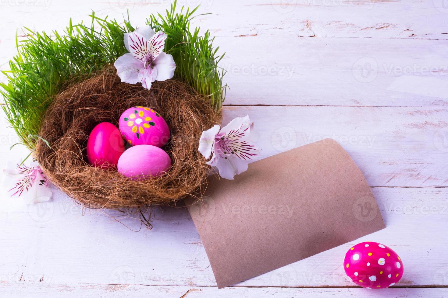 Easter eggs in a nest with white flowers photo