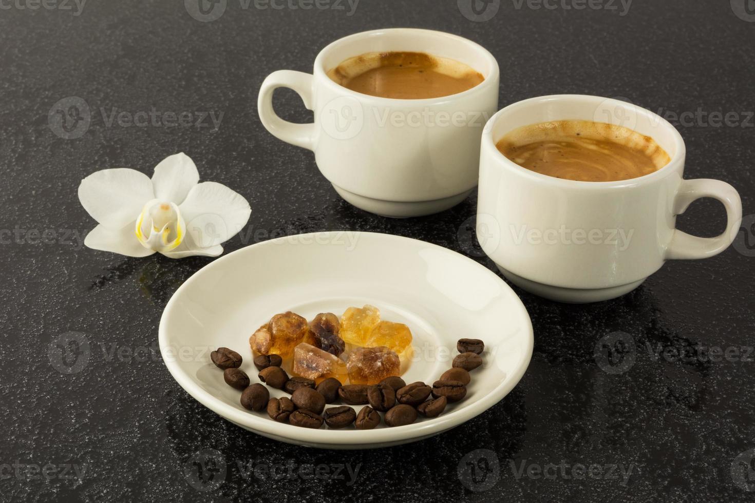 White coffee cups and white orchid photo