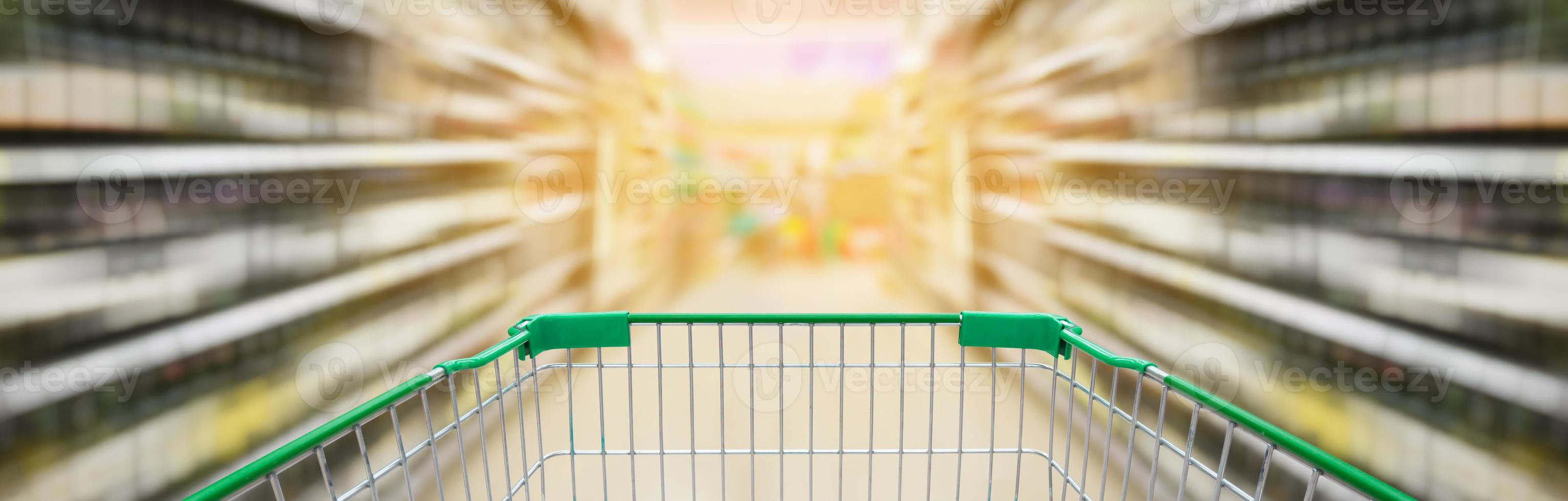 shopping cart with wine bottles shelves in supermarket aisle photo