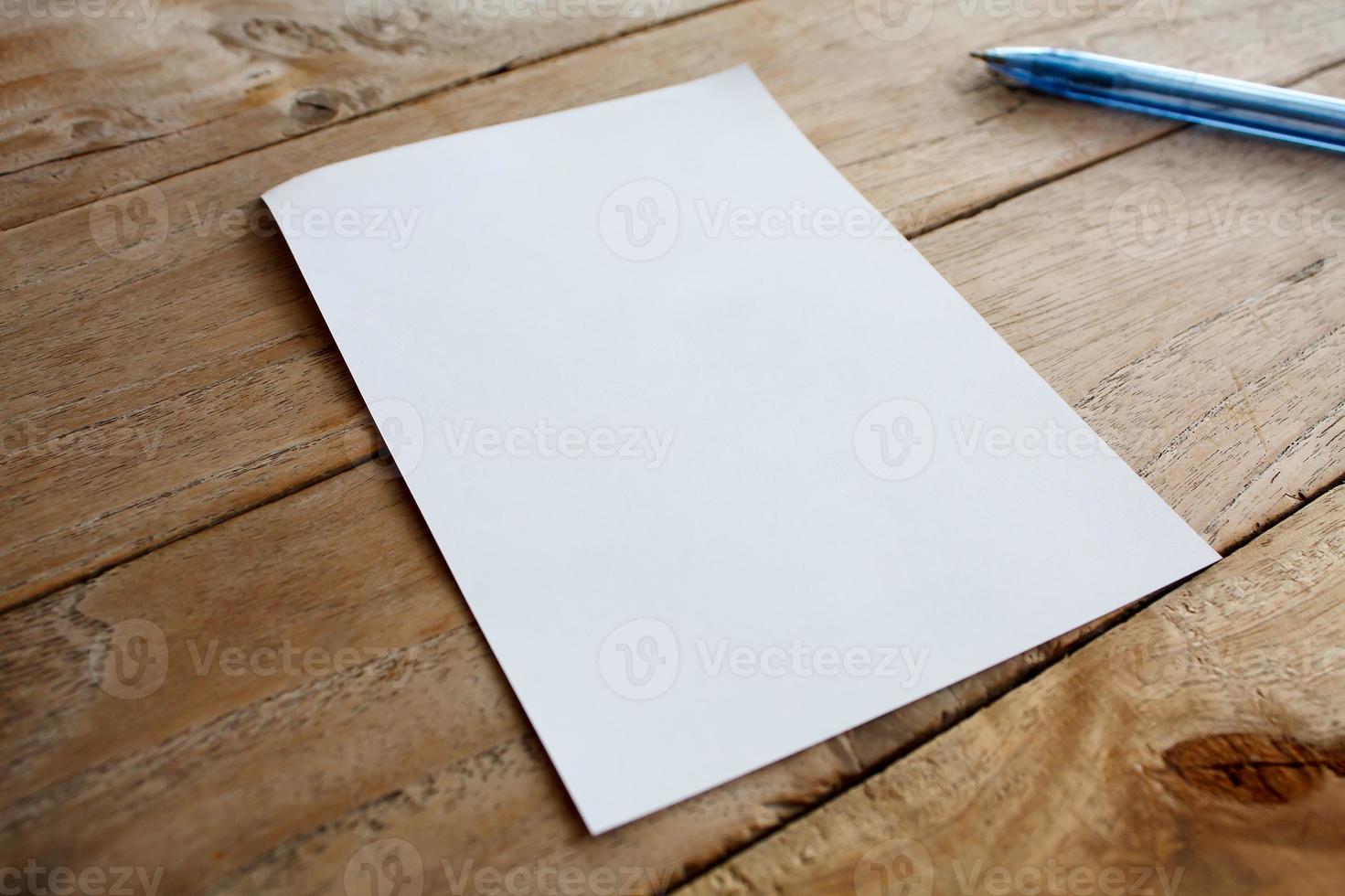 Blank paper on wood table photo