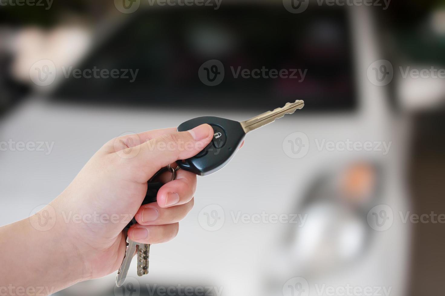 women's hand presses on the remote control car alarm systems photo