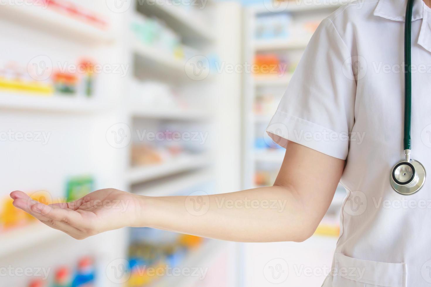 female doctor with shelves filled with medication in the hospital photo