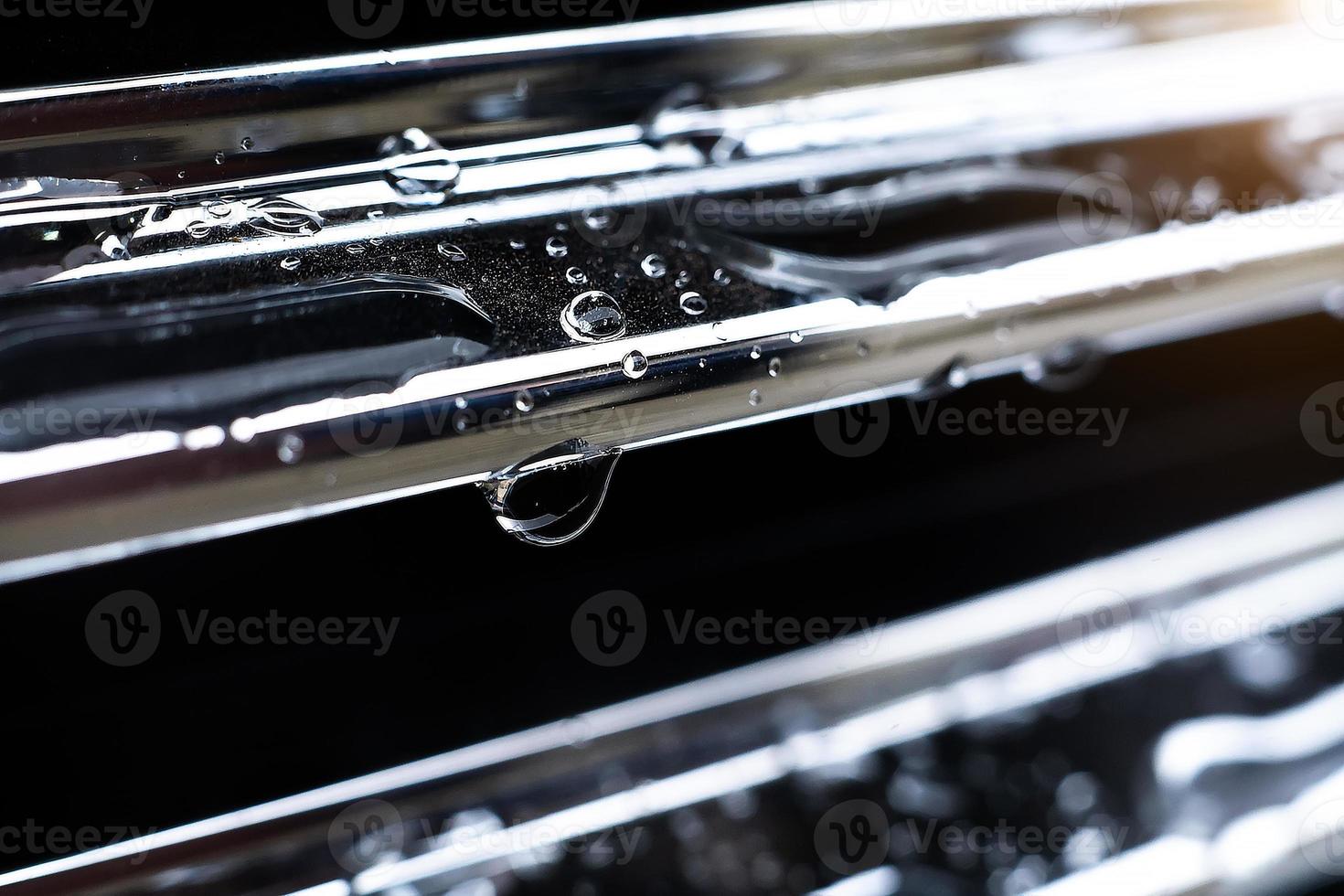 raindrop close-up on the car radiator grille macro photo. photo