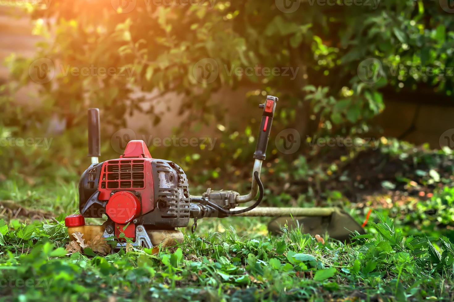 lawn mower lying on the grass photo