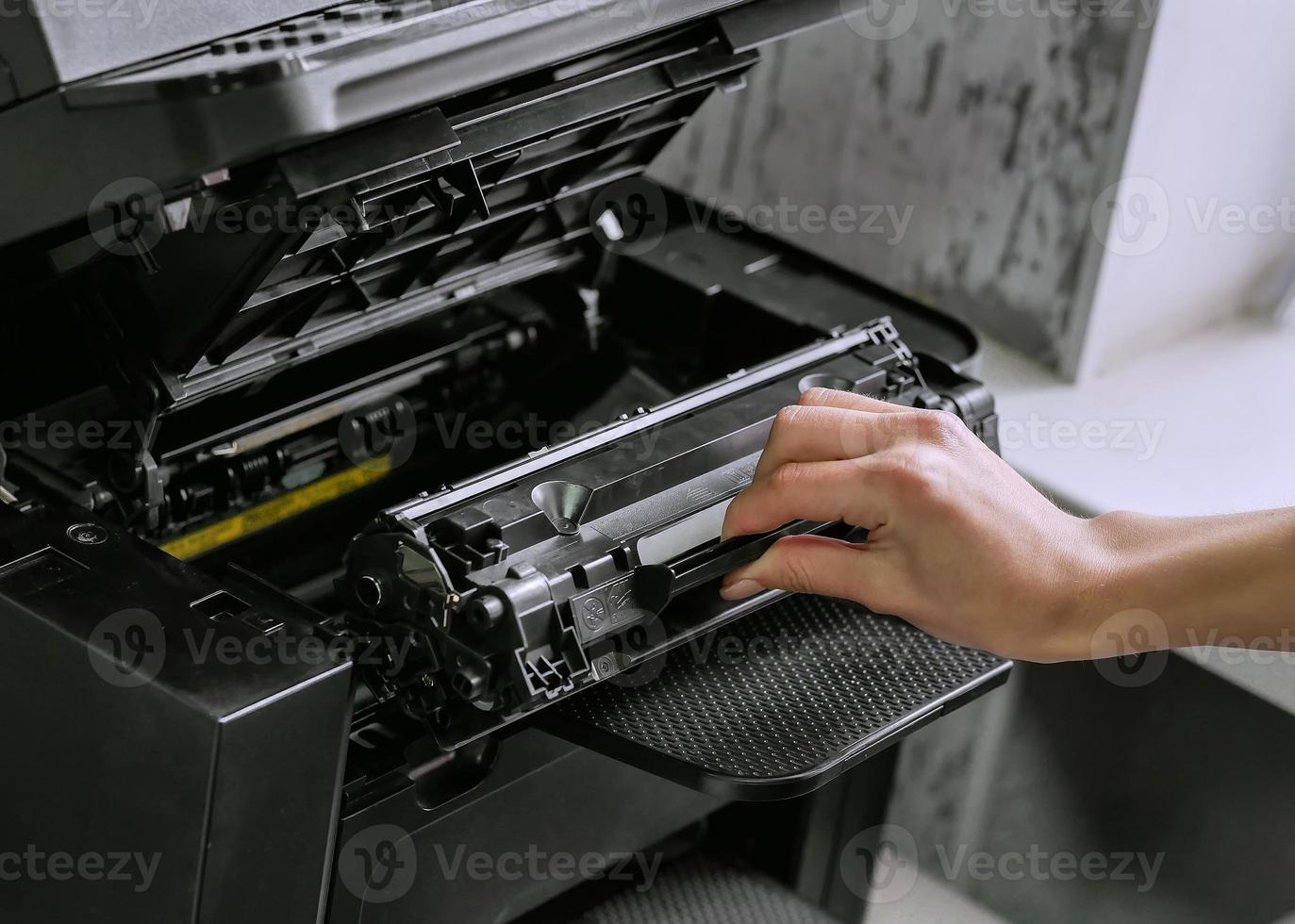 replacing the cartridge in the laser printer photo