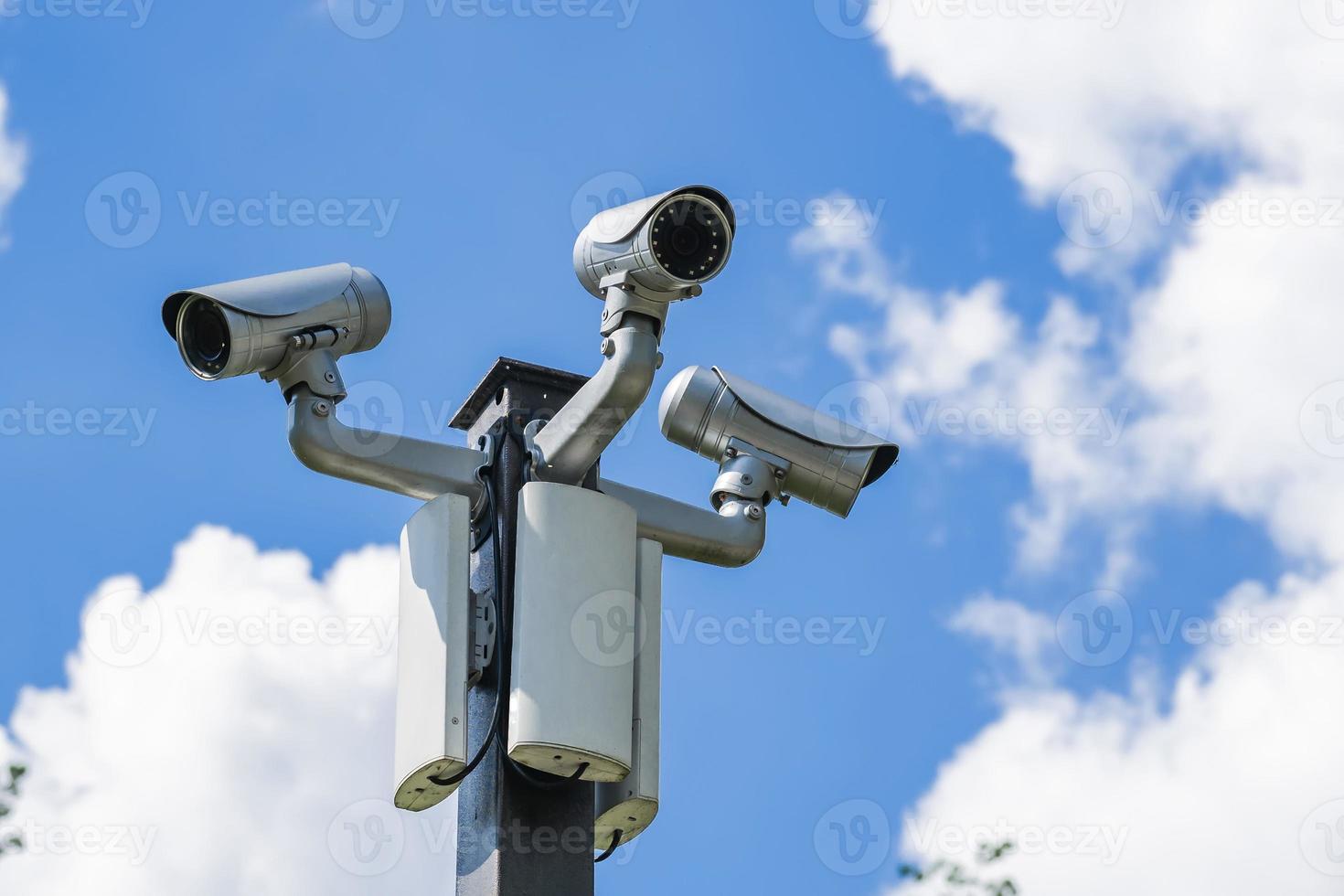 many cameras video surveillance on a pole against the sky 6964070 Stock