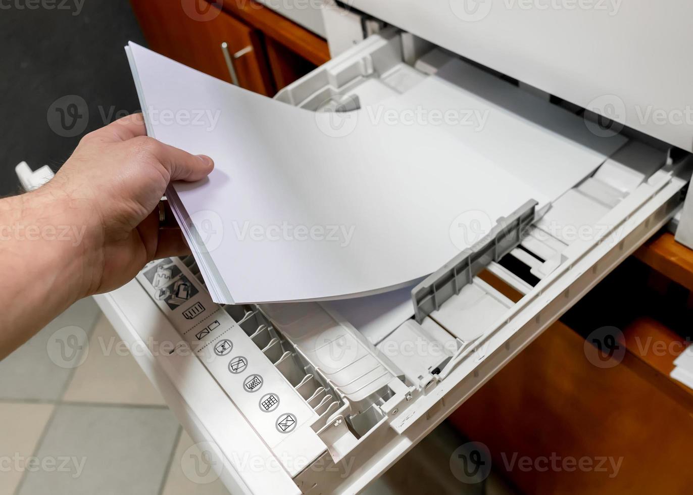 paper in printer. sets the paper stack in the laser printer. photo