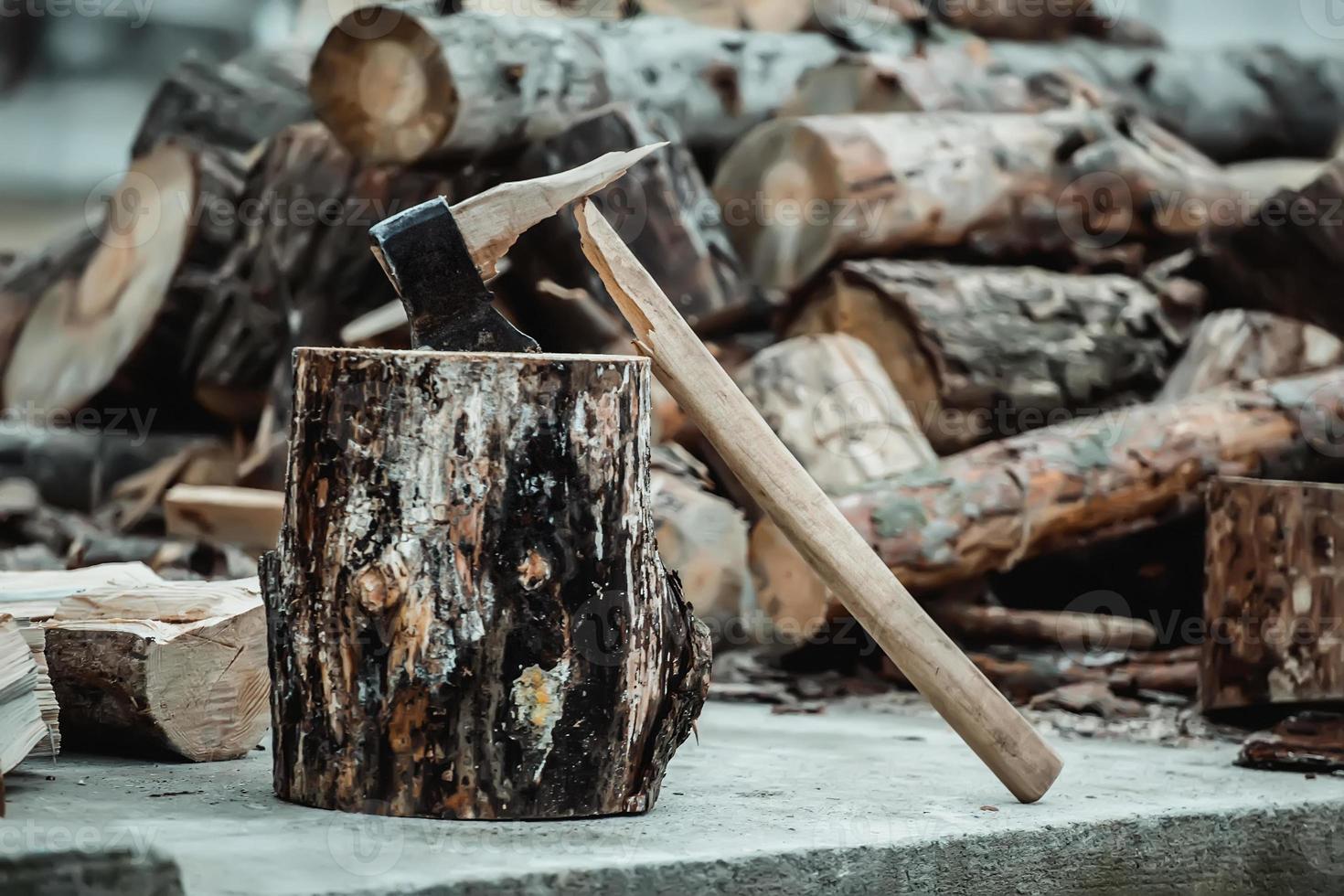 broken axe when chopping wood. The woodcutter broke the tool. photo