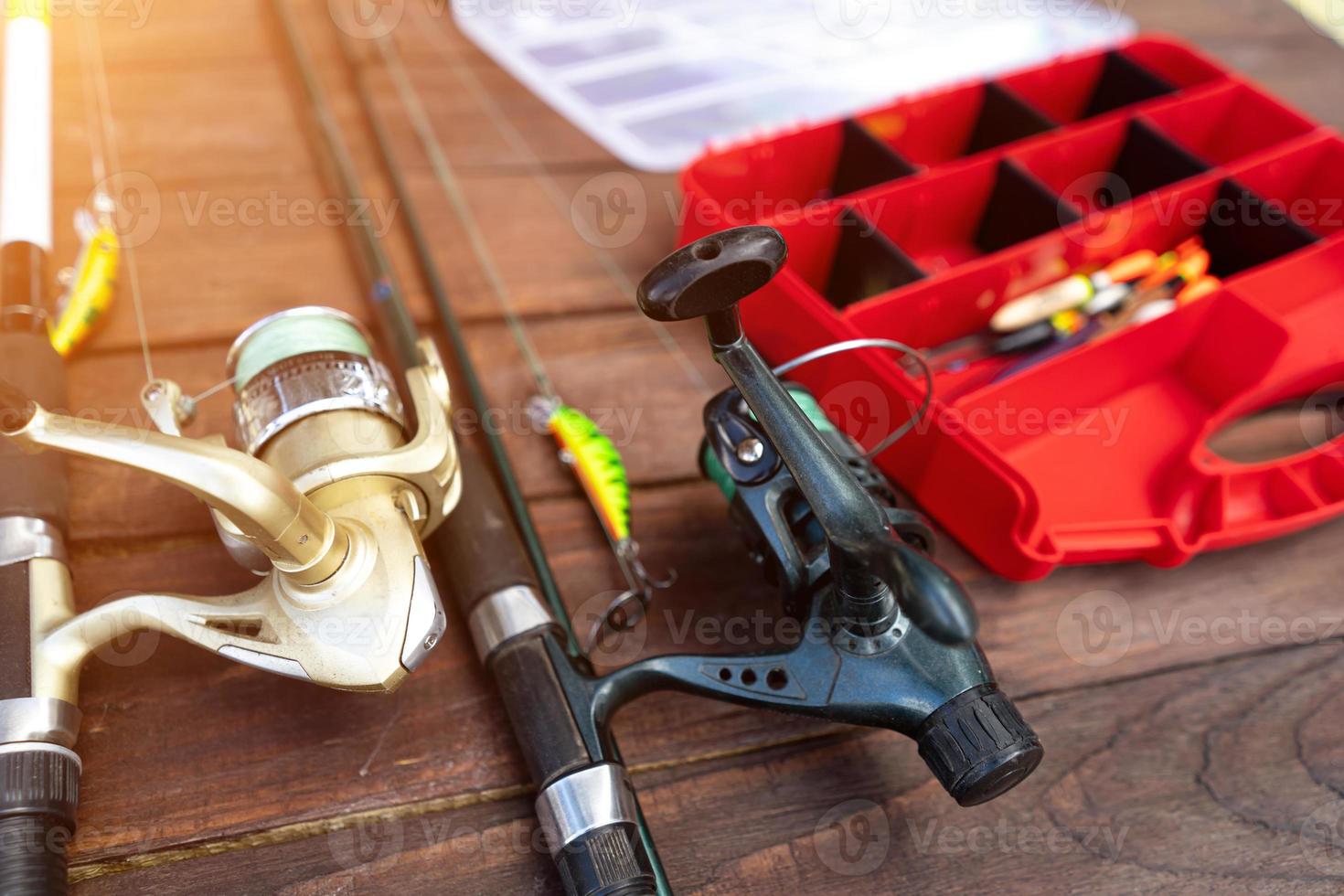 fishing rods and tackle on a wooden background photo