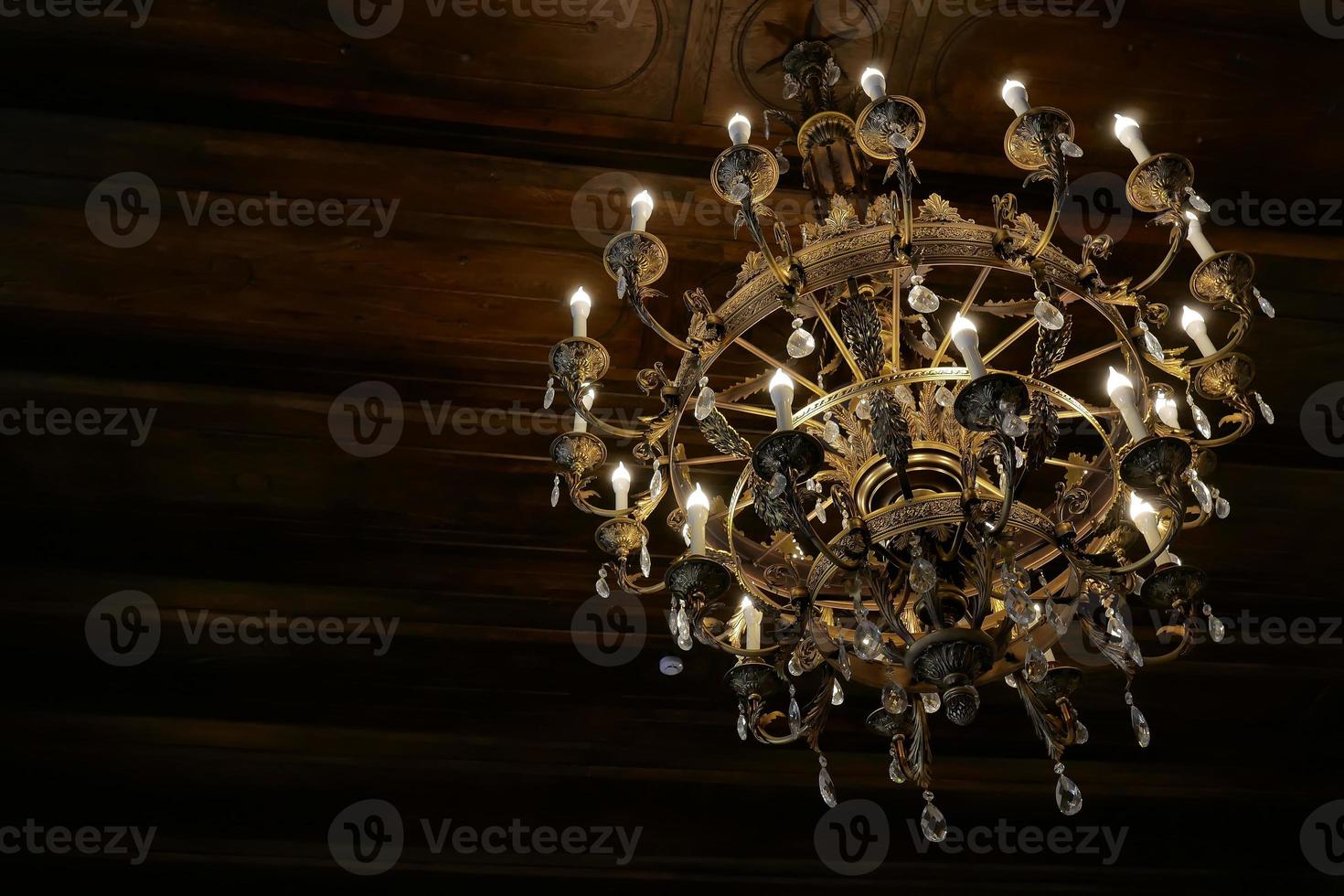old luxury gold chandelier on the ceiling photo