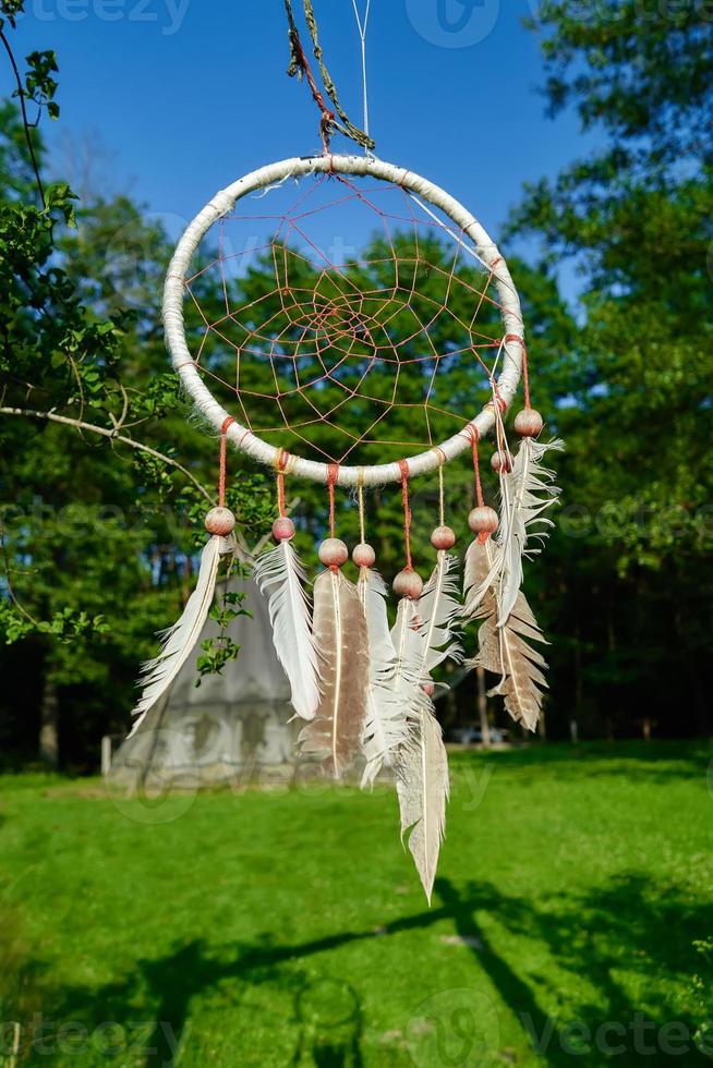 dreamcatcher on the background of an Indian village of wigwams photo
