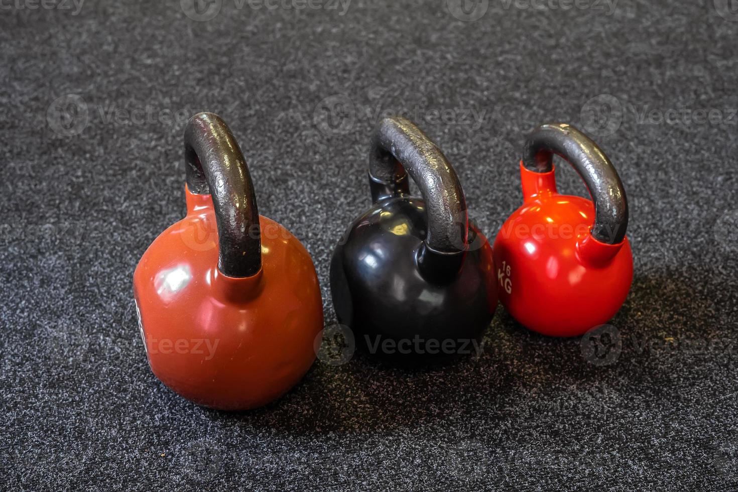 3 weights lie on the floor in the gym photo