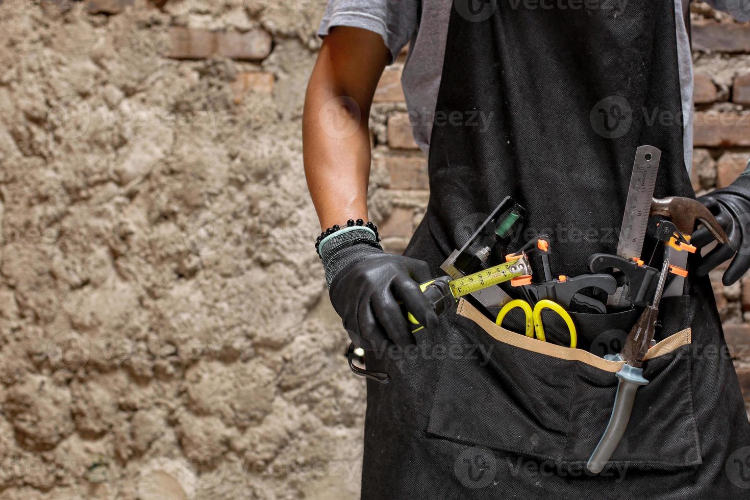 Builder handyman with construction tools for house renovation or carpenter background concept photo