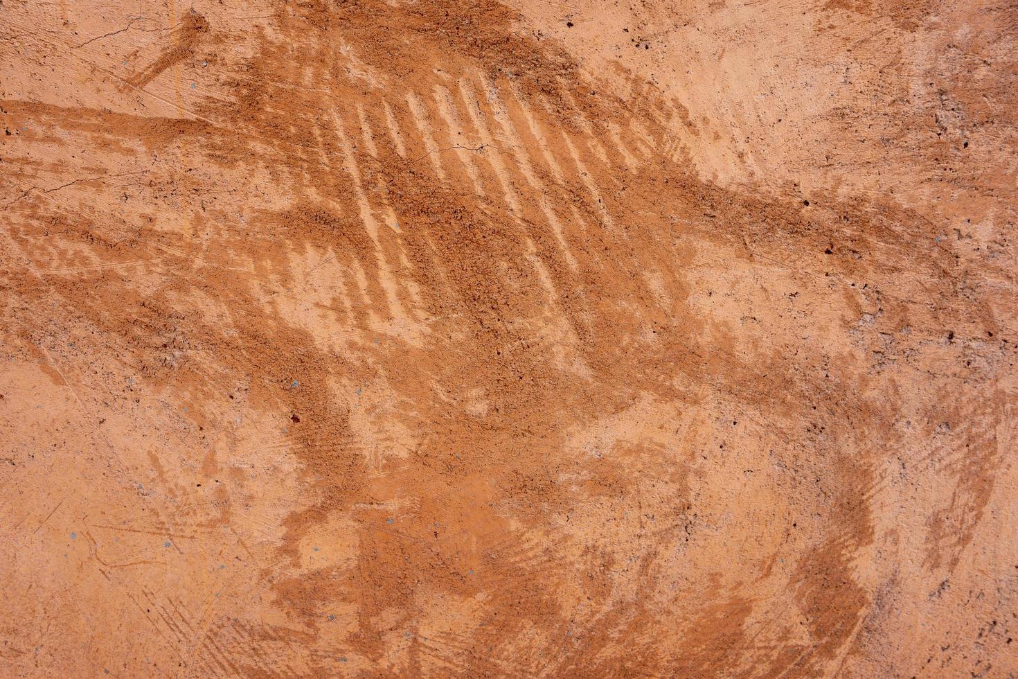 Beige brown exterior plaster wall texture background with scratch and crack pattern photo