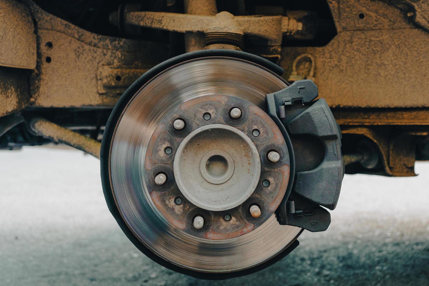 Disc brakes of old cars, vans with broken tires parked on the side of the road to change tires at a rural garage photo