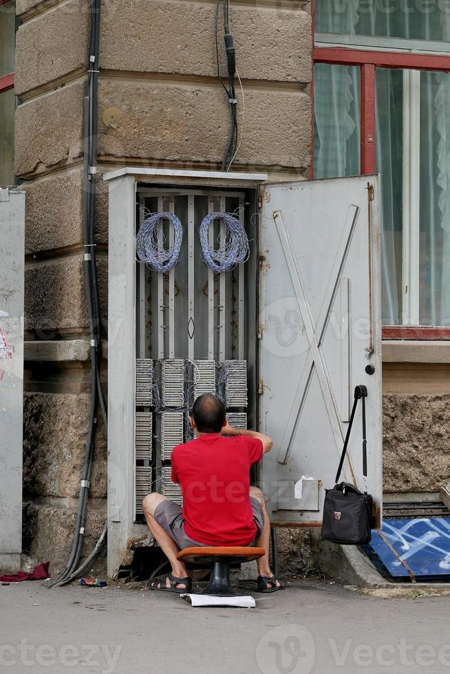 worker troubleshoots the telecommunication booth photo