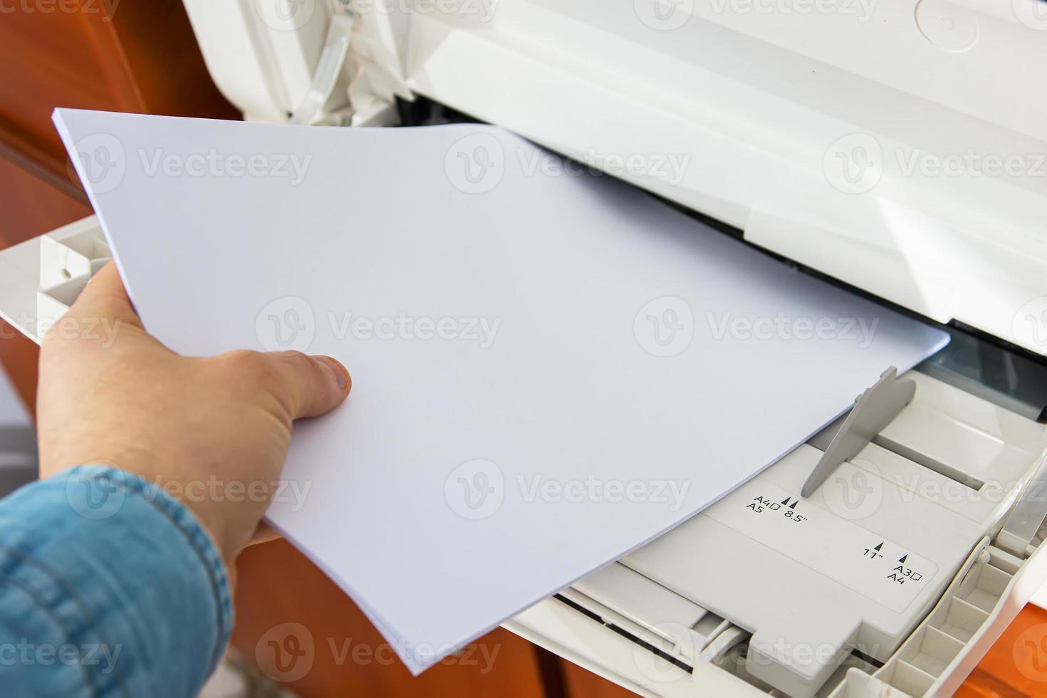 installing paper in the printer close-up photo