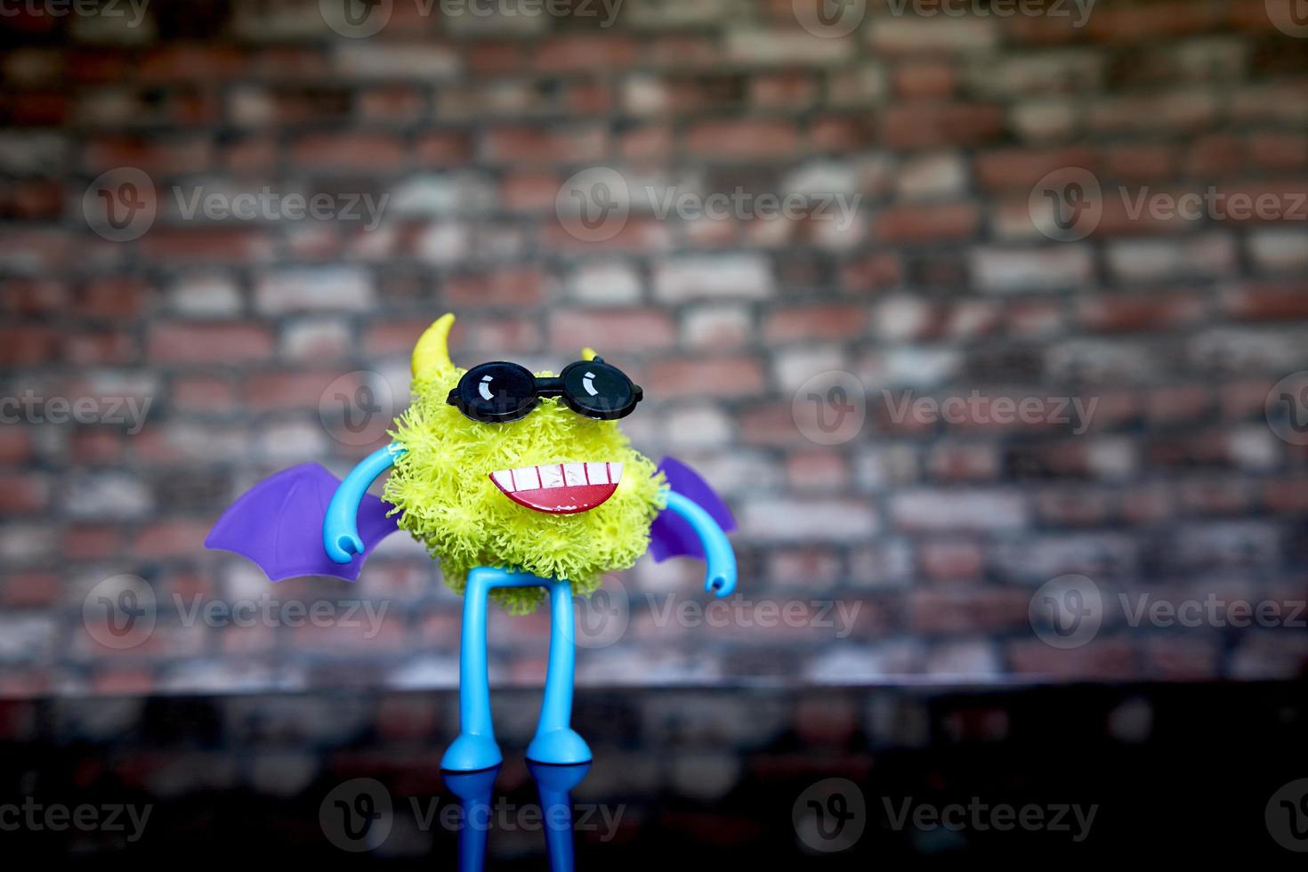 a coronavirus toy figure with glasses and wings on its back. photo