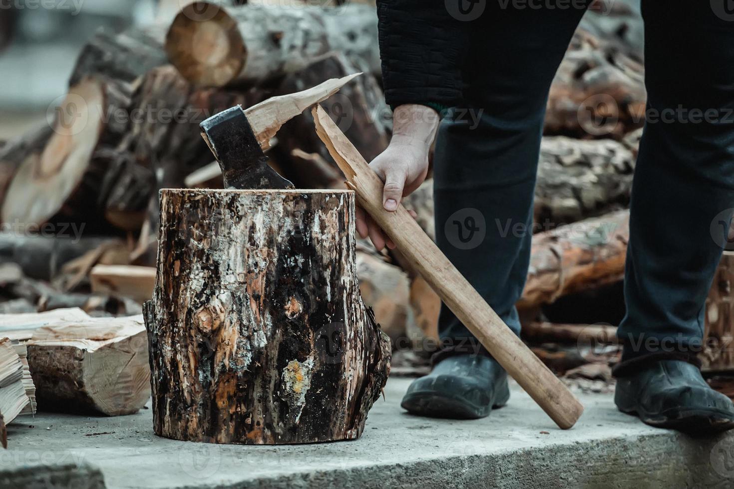 broken axe when chopping wood. The woodcutter broke the tool. photo