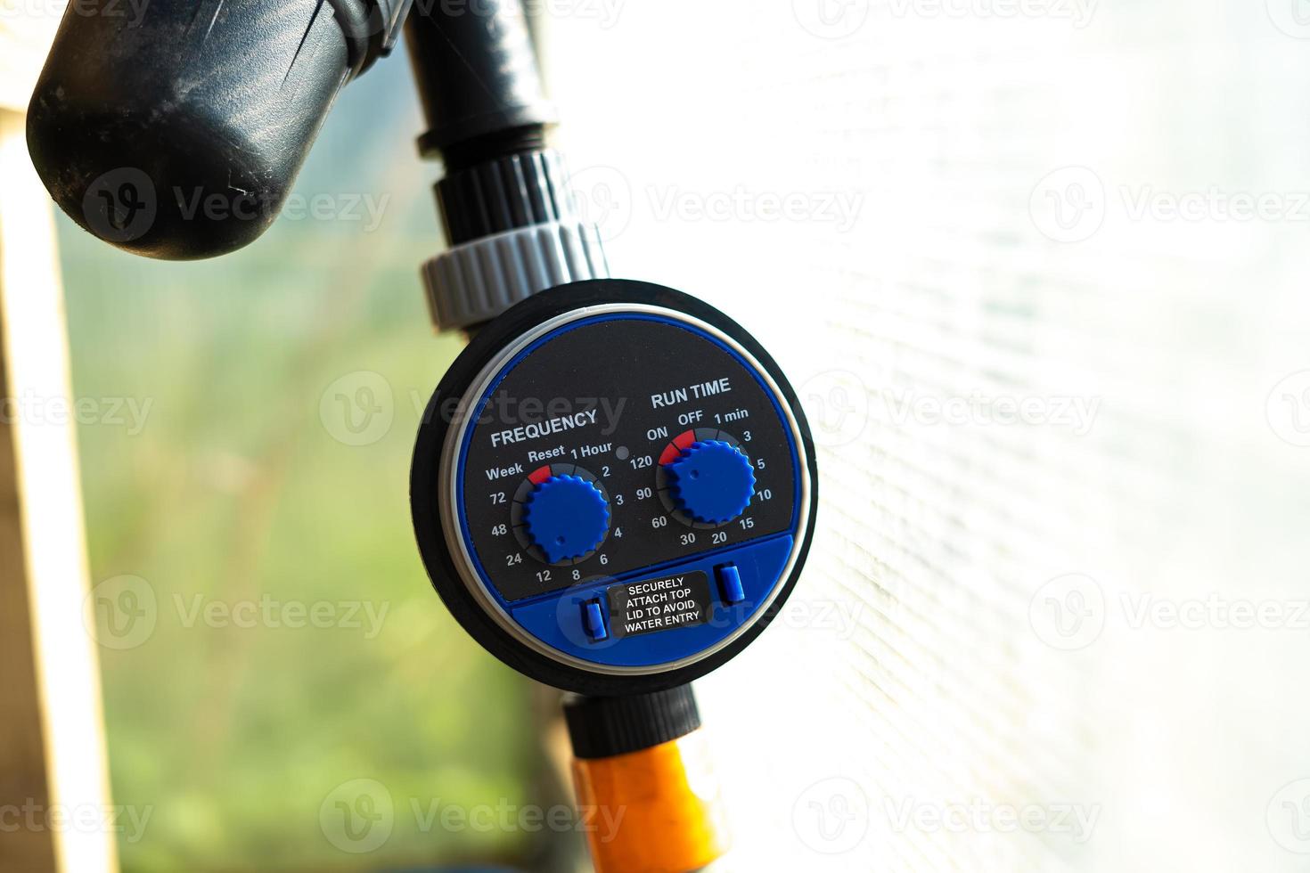 drip irrigation timer in the greenhouse close-up photo