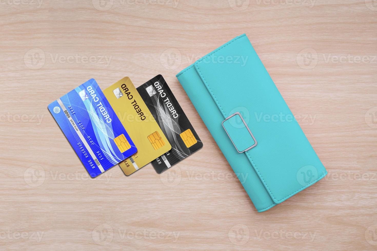 Cyan wallet and credit cards on wood table background. photo