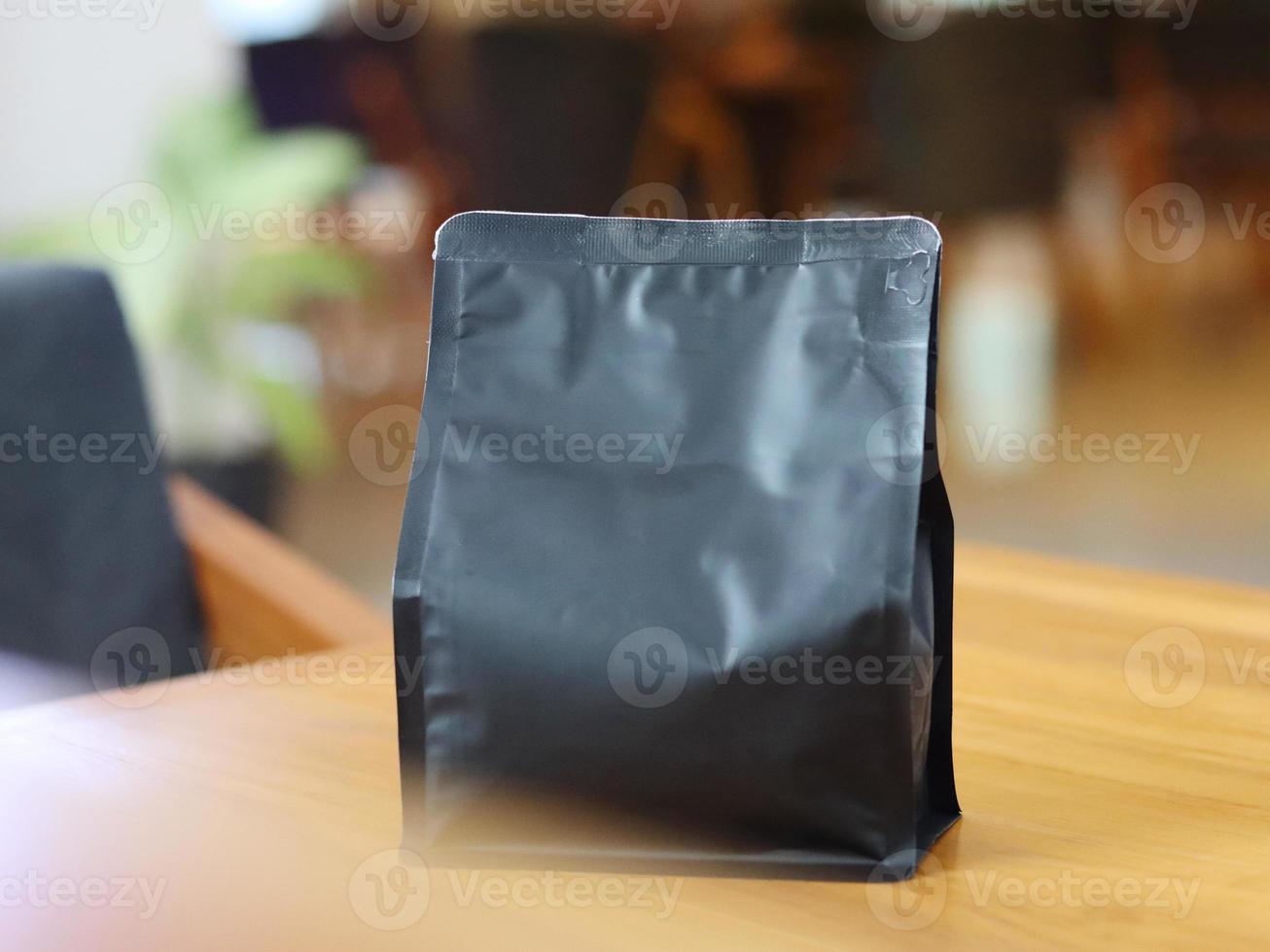 Photo of standing pouch coffee packaging on the cafe table. suitable for mock up label stickers, coffee variant packaging stickers or etc.