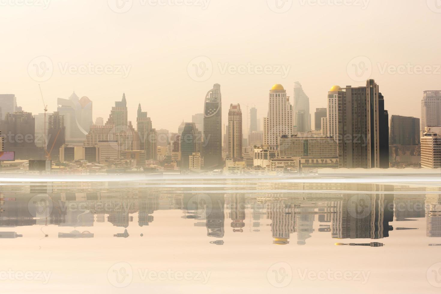 Beautiful landscape abstract city background and The light of sun reflection building on water. photo