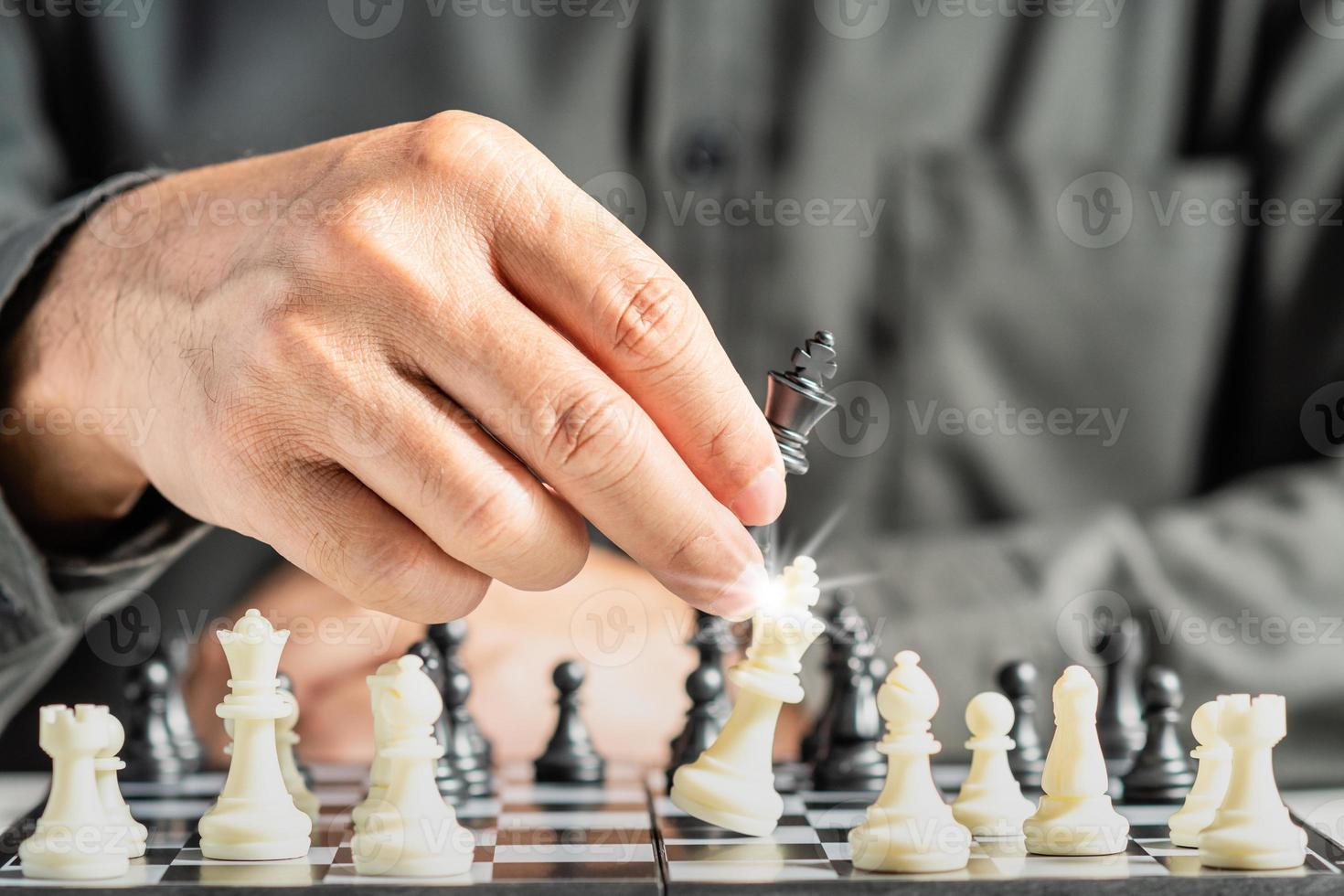 The hands of a business male business associate confident in strategy after playing chess to analyze and develop new planning. Concept of leadership and teamwork for victory and success in business. photo