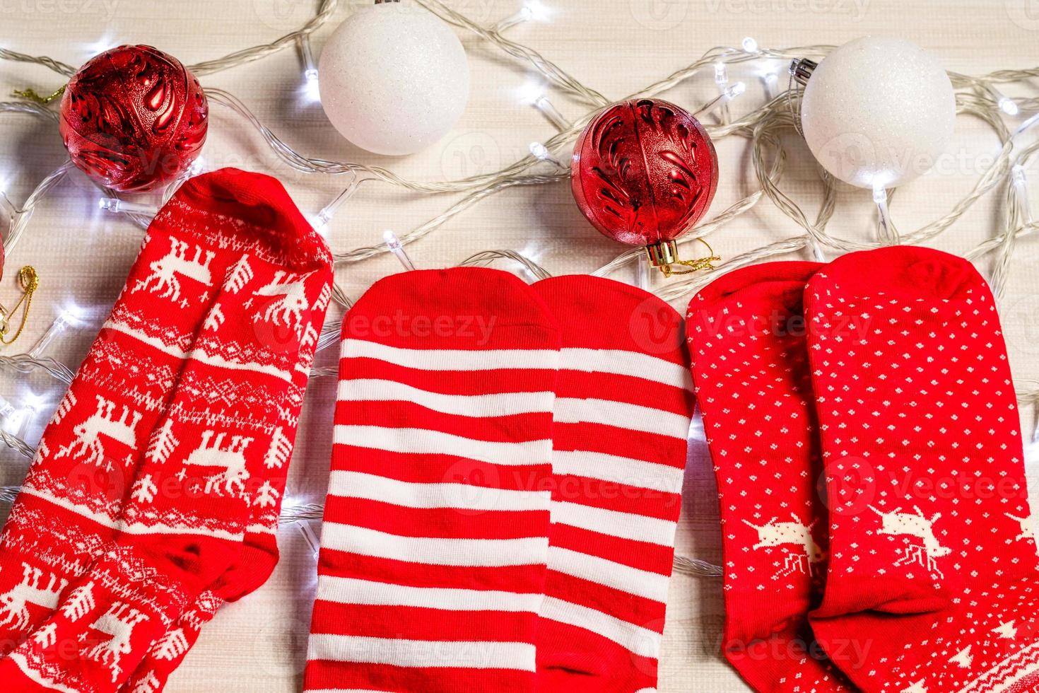 The sock placed on a wooden table in living room. Concept for the Christmas season, ball red and white, lights, bright, holiday, nobody, Closeup photo