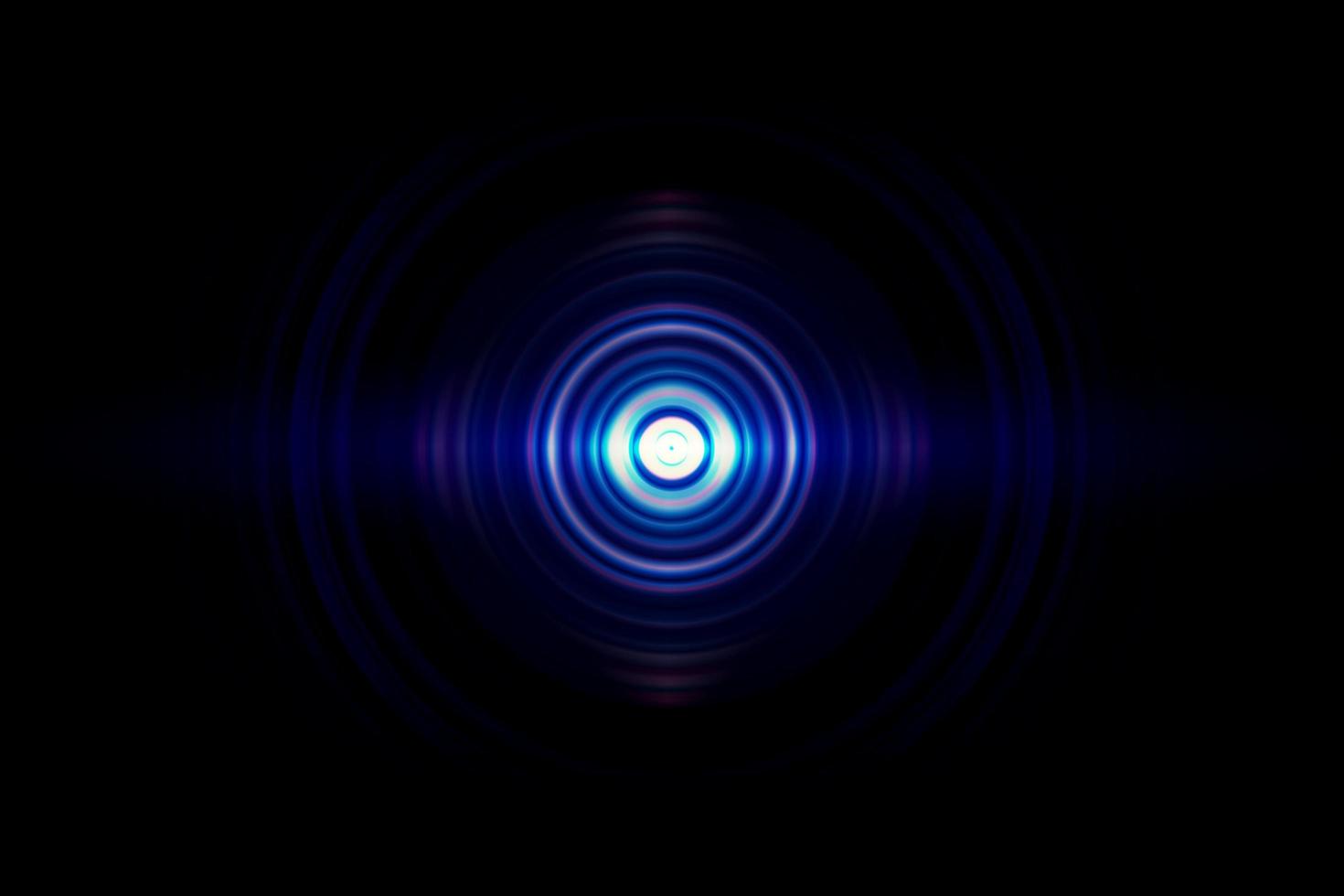 Abstract glowing circle blue light effect on black background photo