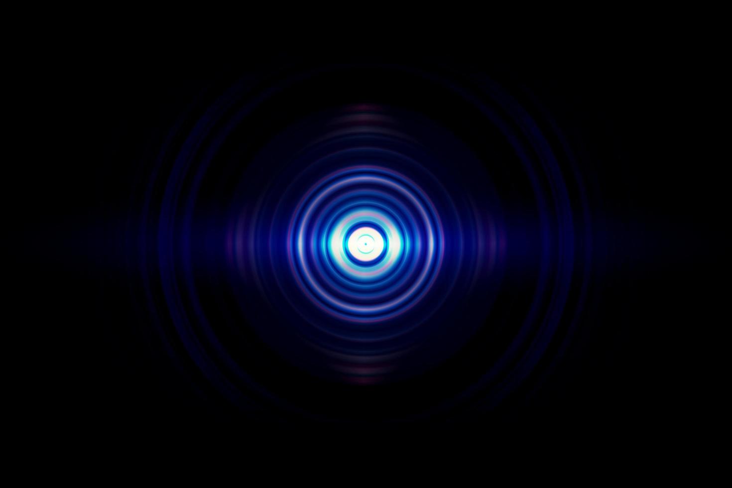 Abstract glowing circle blue light effect on black background photo