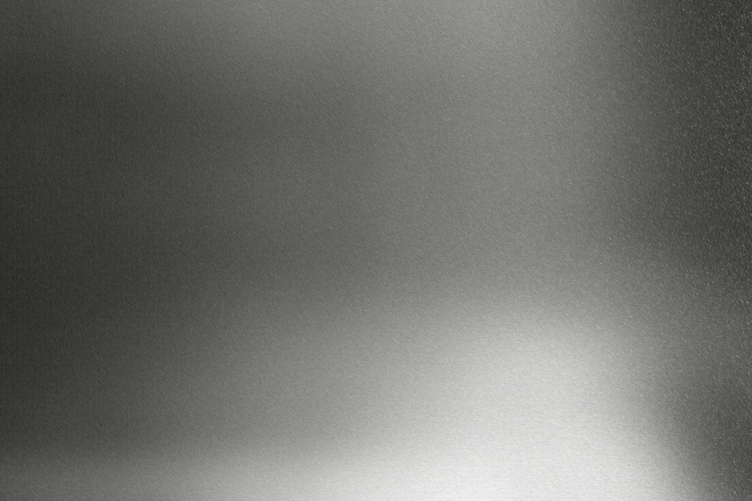 Brushed black metallic wall with scratched surface, abstract texture background photo