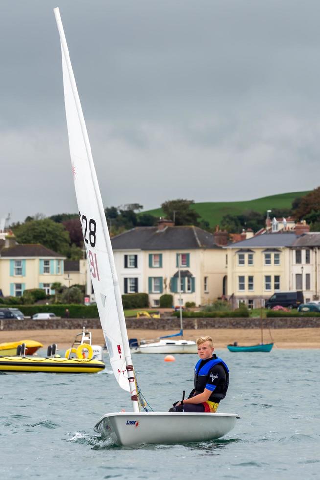 APPLEDORE, DEVON, UK, 2013. Young man sailing in the Torridge and Taw Estuary in  Devon photo