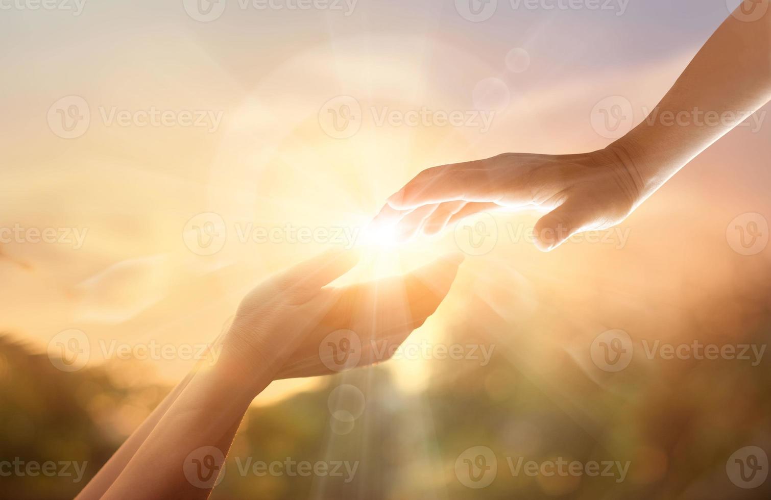 God's helping hand with the white cross on sunset background. Day of remembrance and good friday concept photo