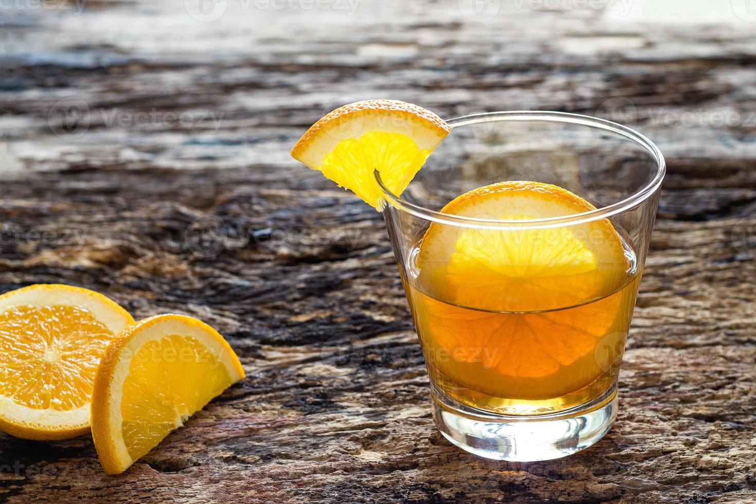 Infused water, detox diet water of orange in glass on wooden, healthy concept photo