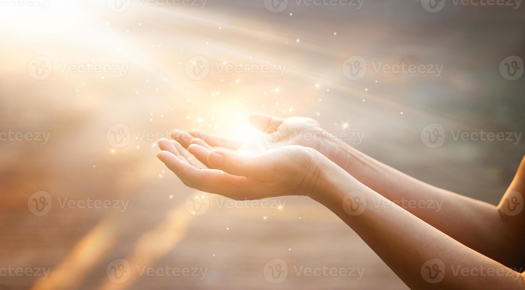 Woman hands praying for blessing from god on sunset background photo