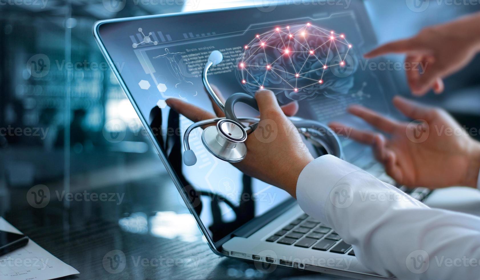 Doctor team meeting and analysis. Diagnose checking brain testing result with modern virtual screen interface on laptop with stethoscope in hand, Medical technology network connection concept. photo