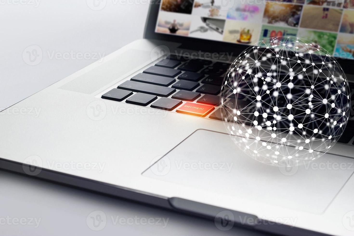 Global network and payment button on laptop, shopping online concept photo