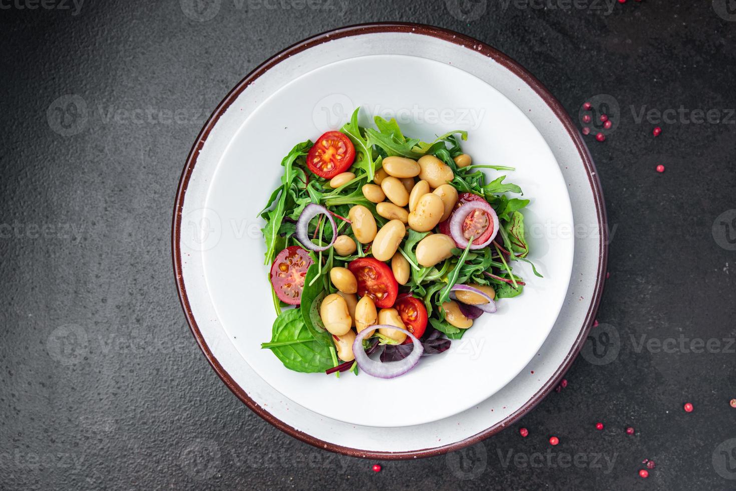 salad bean tomato, onion, lettuce leaves mix fresh healthy meal diet snack on the table copy space food background keto or paleo diet photo