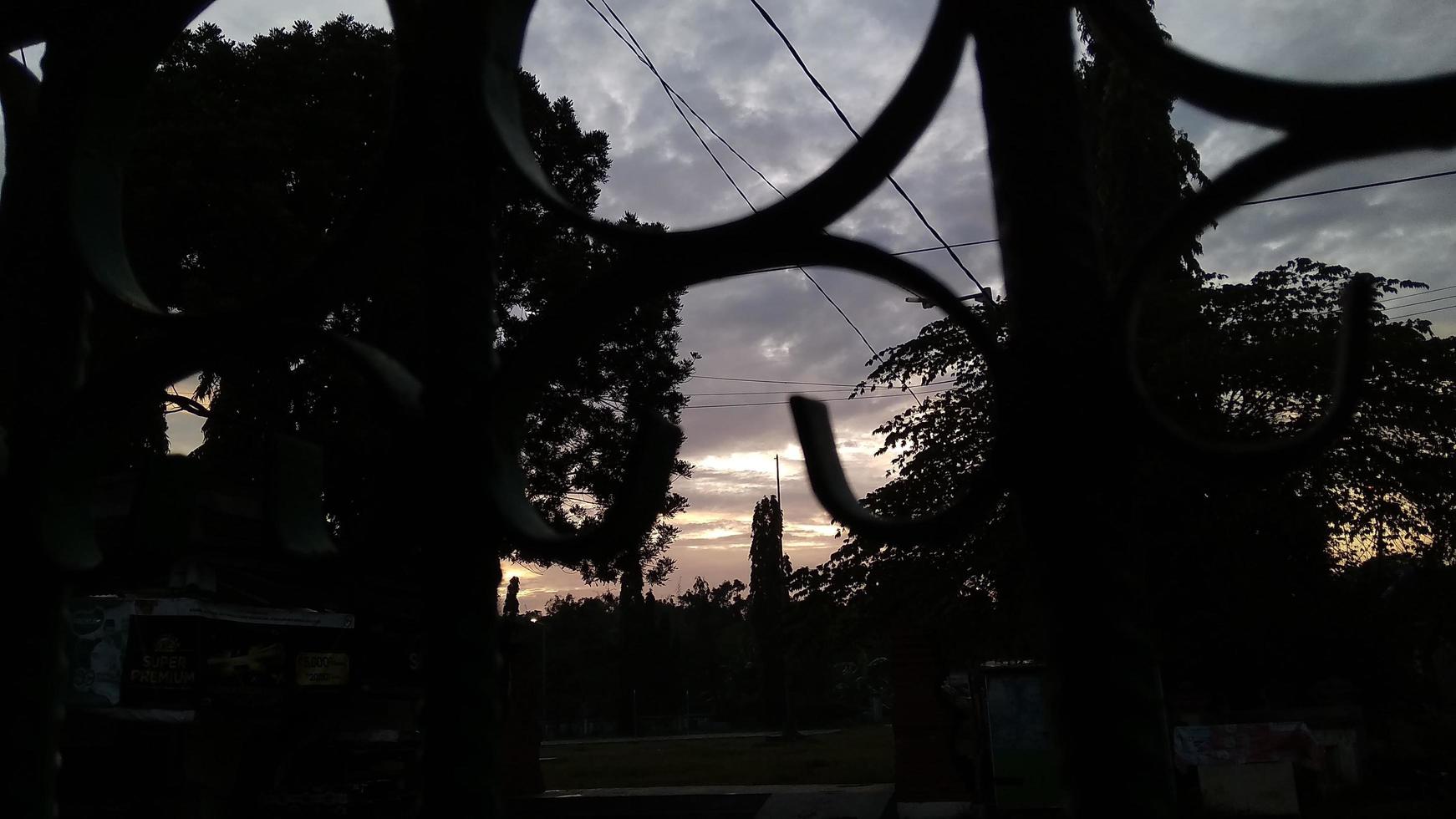 The view in the morning at sunrise seen from behind the iron fence photo