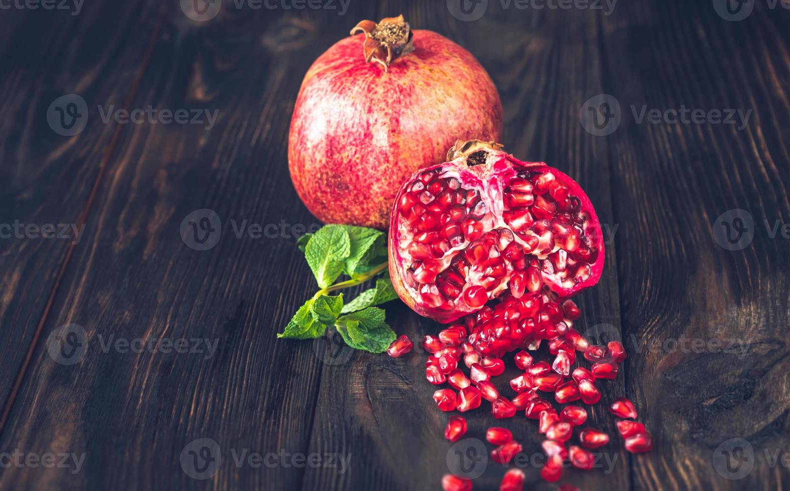 Fresh pomegranate on the wooden table photo