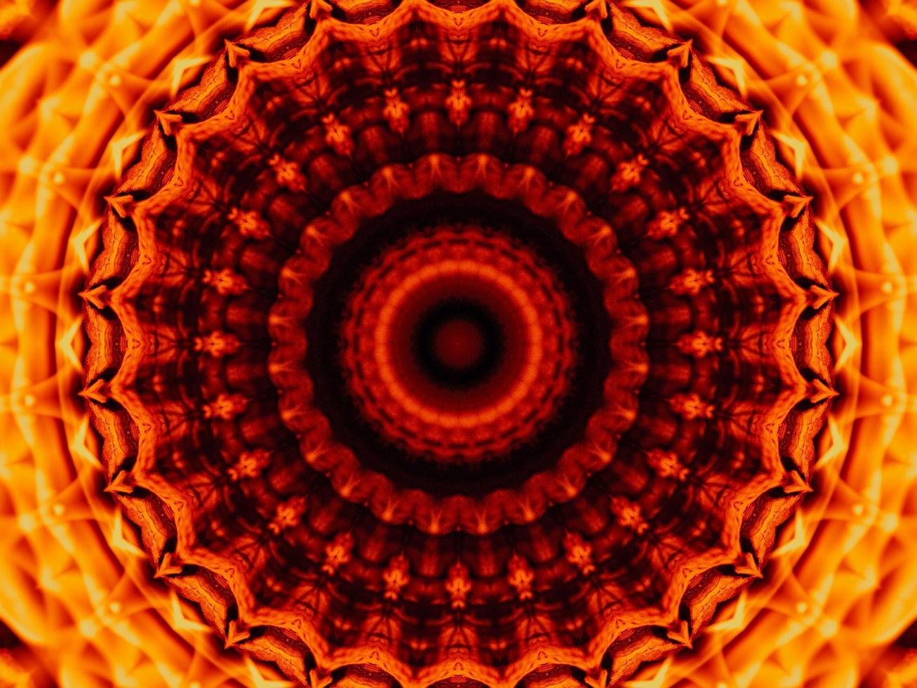 Unique abstract background. Orange flames kaleidoscope pattern. Free Photo