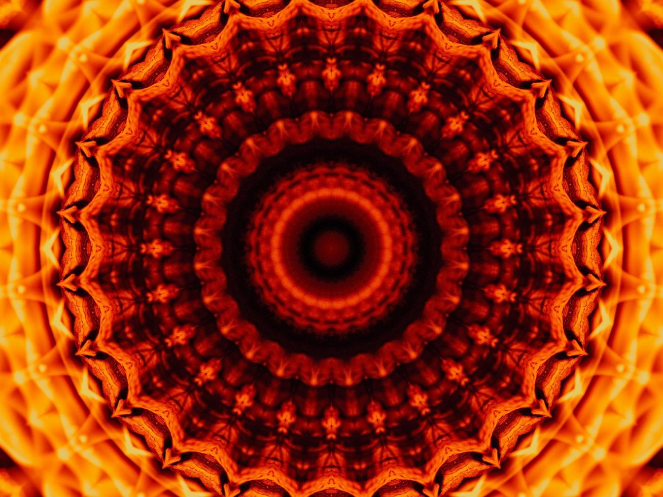 Unique abstract background. Orange flames kaleidoscope pattern. Free Photo