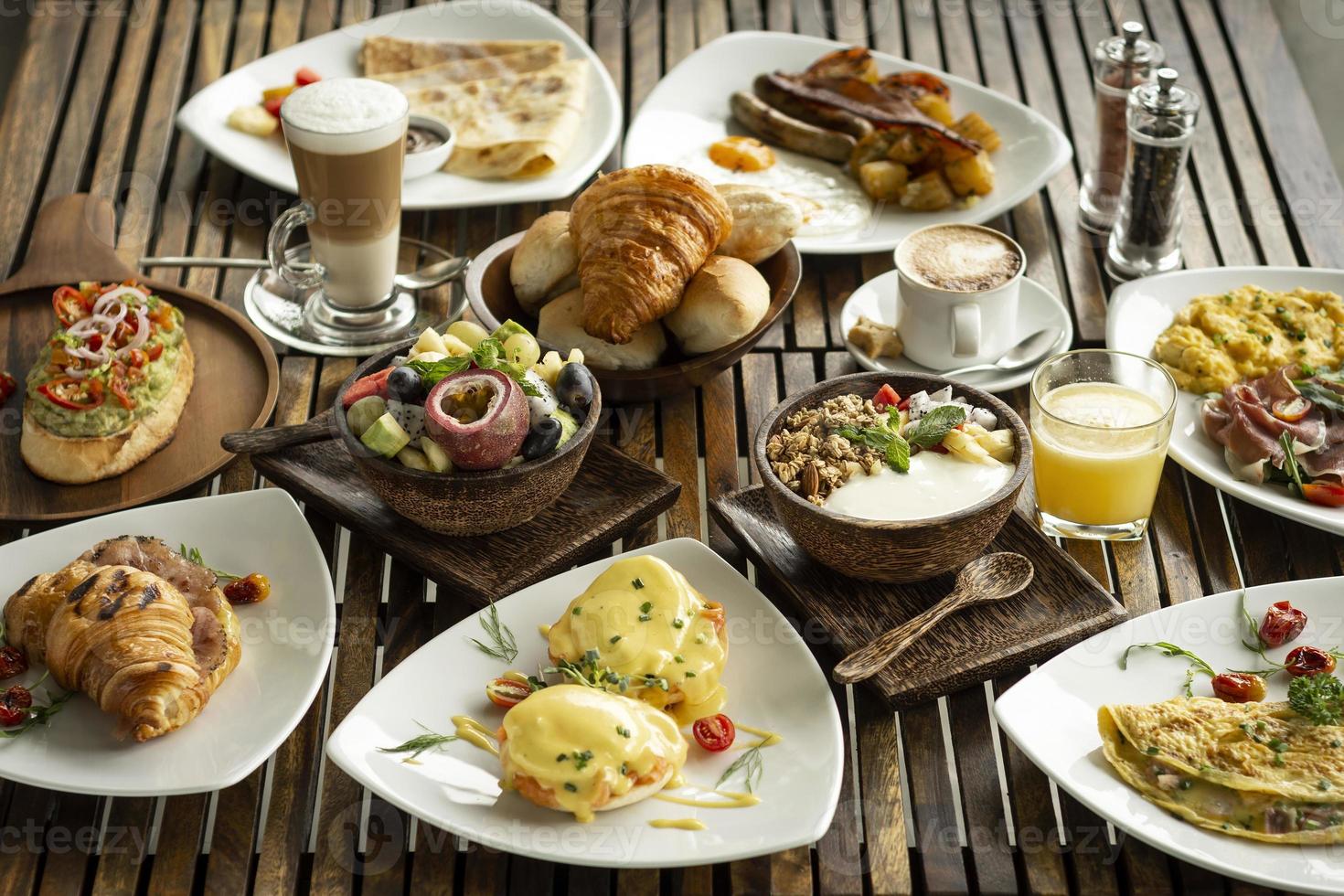 Western big gourmet breakfast selection mixed dishes on restaurant table photo