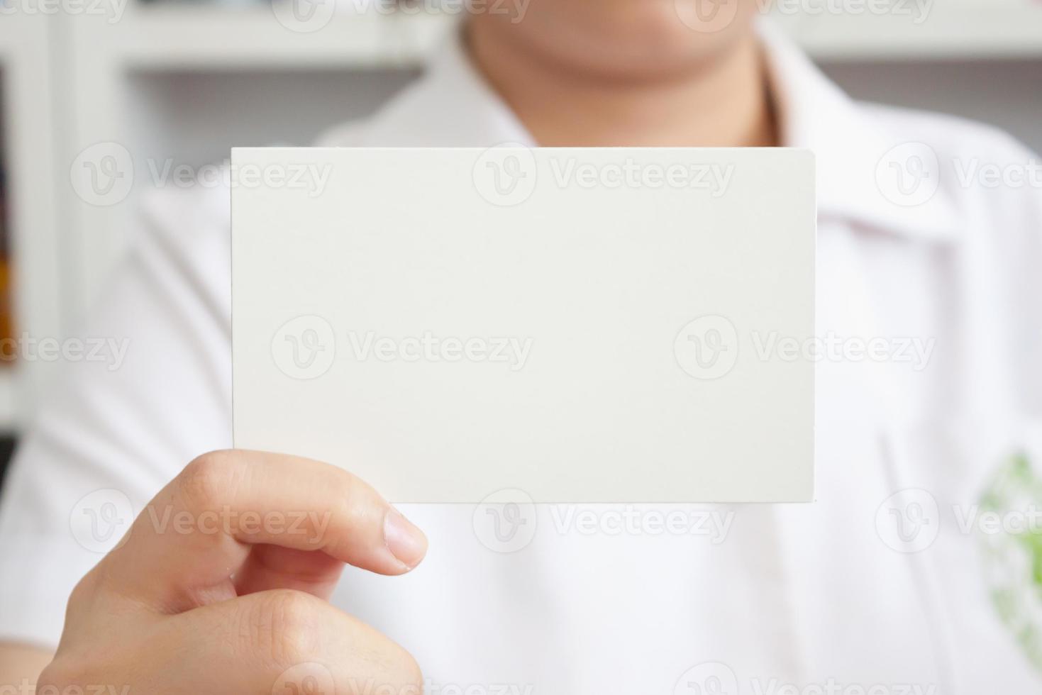 pharmacist holding blank paper in the pharmacy store photo