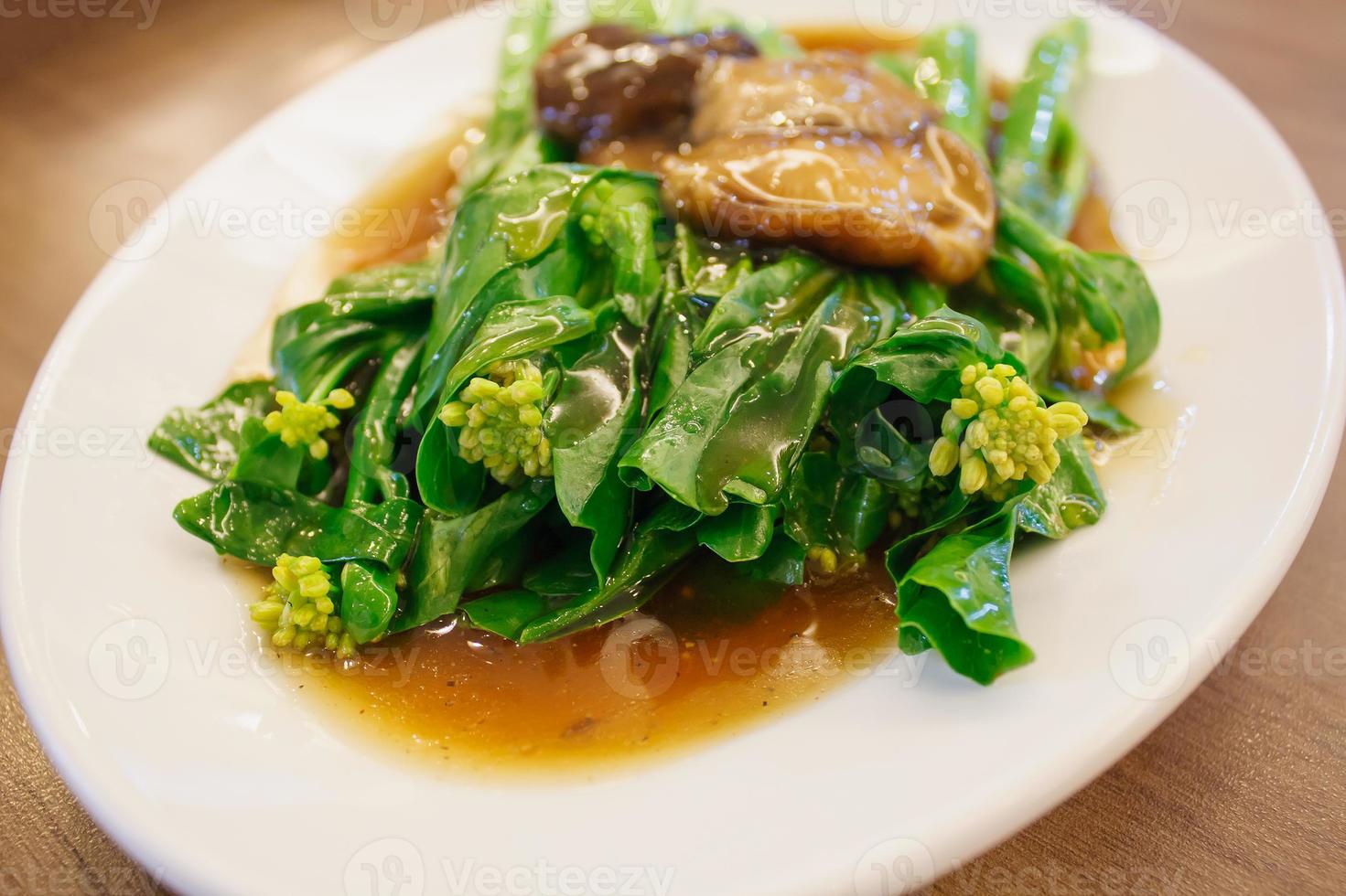 Stir-fried chinese broccoli and shiitake mushroom in oyster sauce photo