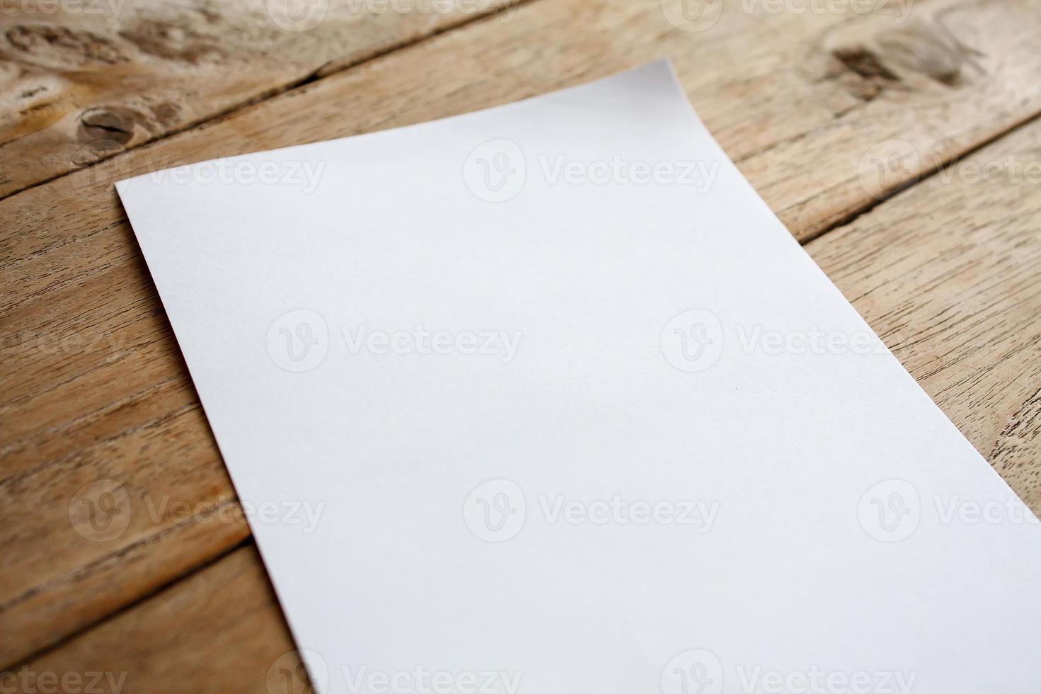 Blank paper on wood table photo