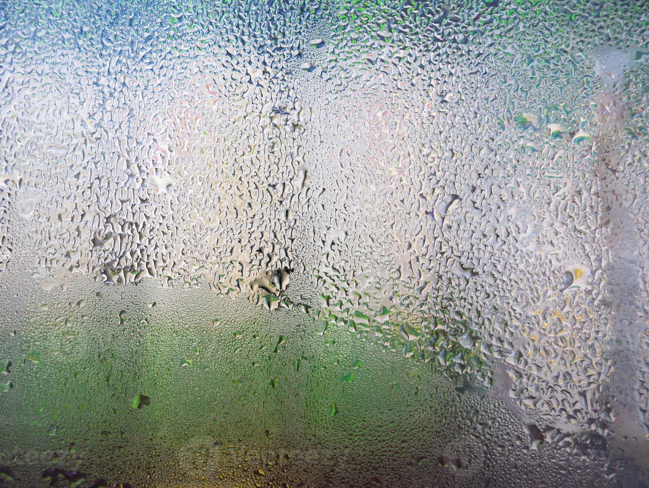 water drops on supermarket refrigerator glass photo