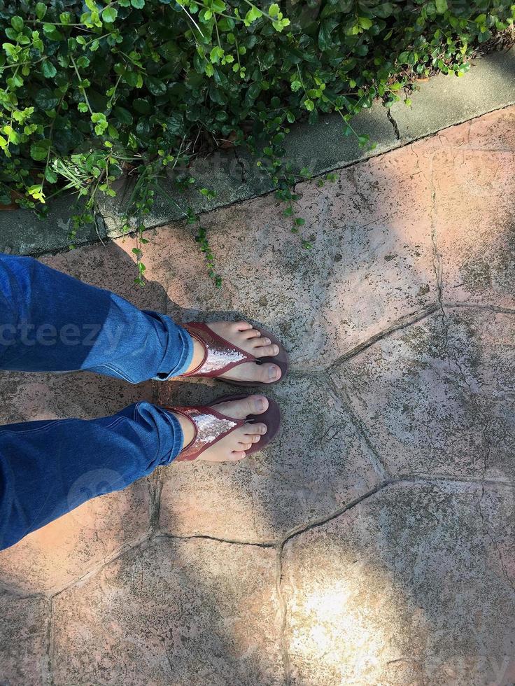 Top view of cement floor and human feet photo