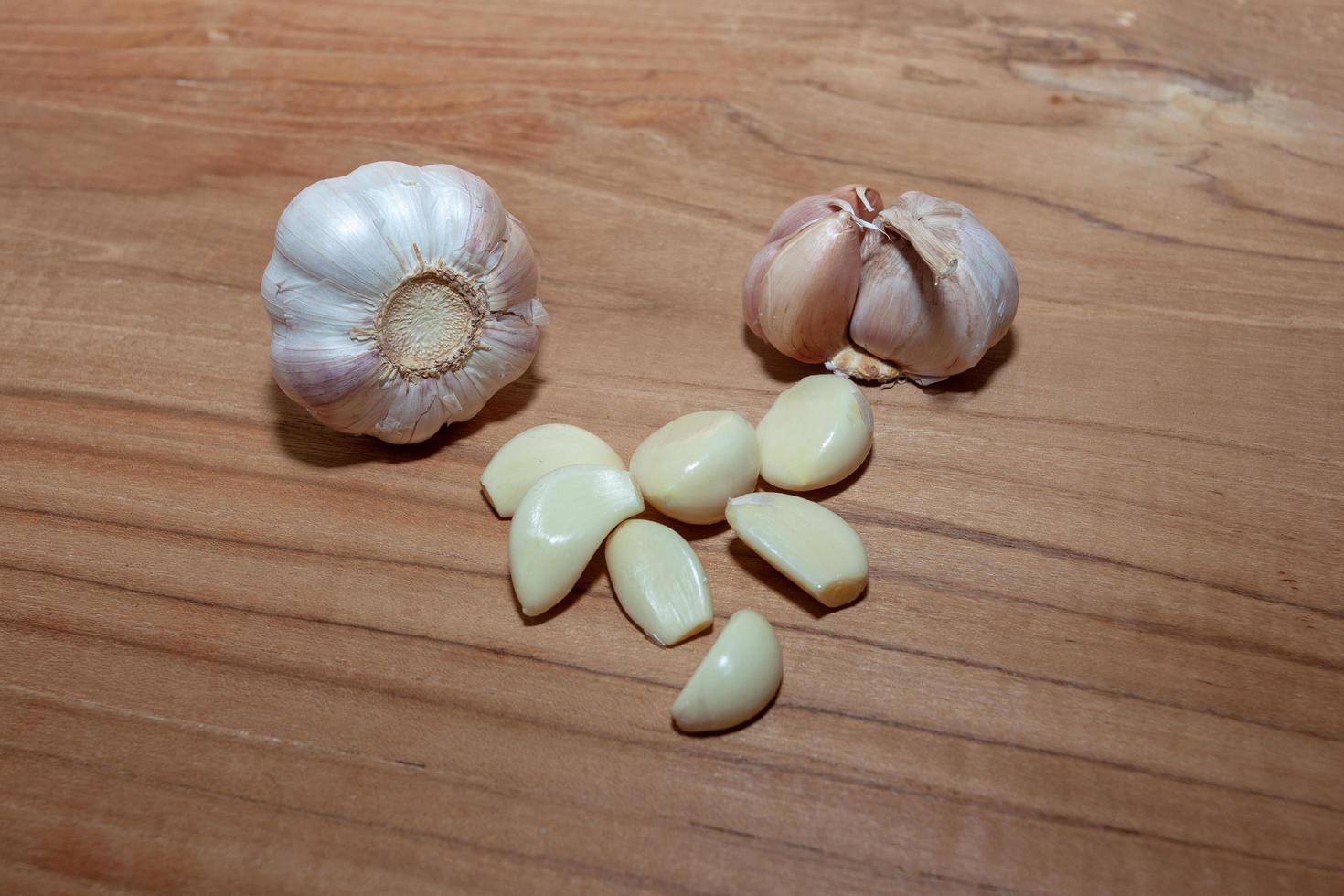 white garlic on wooden floor for cooking photo